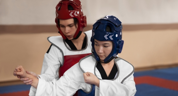 Students in karate uniforms practice together, highlighting the importance of extracurricular activities at AISM.