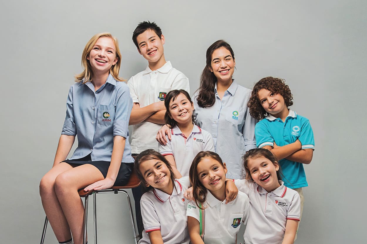 Students in school uniforms pose for a photo, showcasing AISM Heritage - part of Taylor's Education Group since 2007 with dedication to the Australian syllabus and visible learning approach.