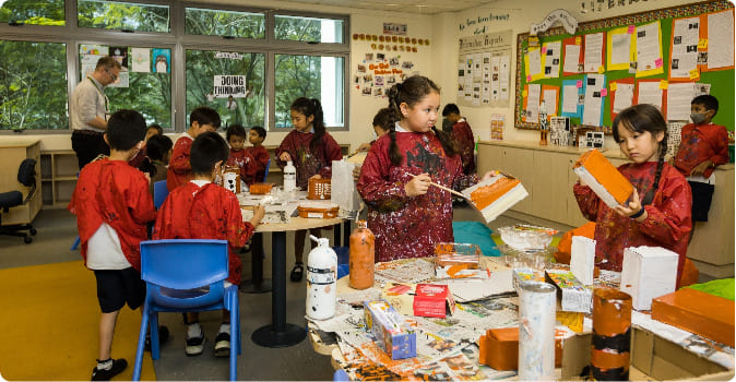 Students participating in arts and crafts with a teacher, showcasing the importance of co-curricular activities in education.